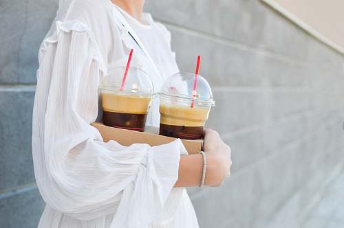 iced coffee woman carrying disposable cups coffee